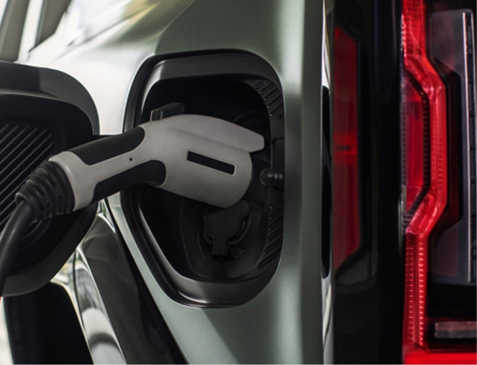 Close up of charging port with charger plugged in on a GMC Hummer EV SUV - Taylor Automotive GMC in MARTIN TN